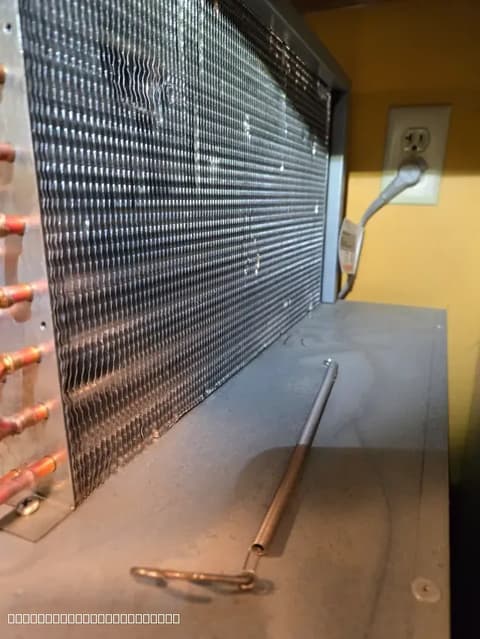 Refrigerator coil repair in progress by a certified technician in Elk Grove, focusing on restoring optimal cooling efficiency.