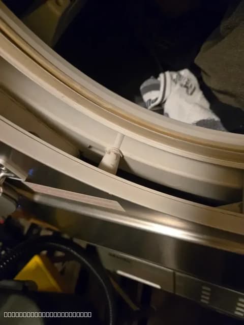 Close-up of a washing machine door seal replacement in Elk Grove, CA, showing the old seal being removed for a new installation by Luxe Appliances Repairs.